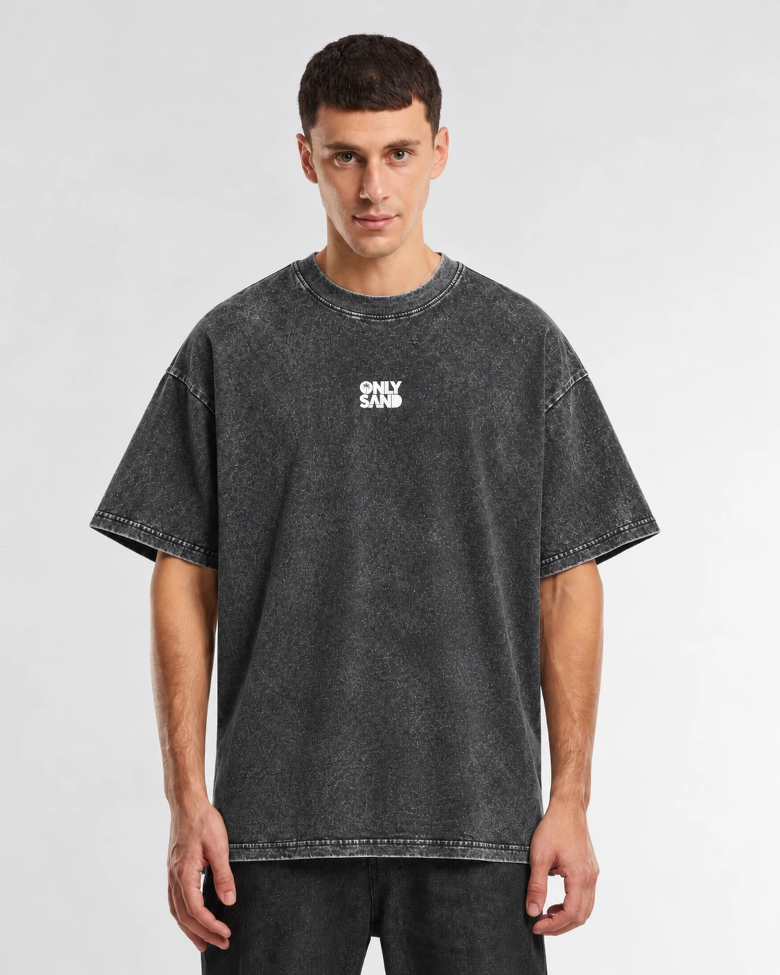 Front view of the BSCM CAPSULE washed charcoal-black T-shirt with a small white ONLY SAND logo.
